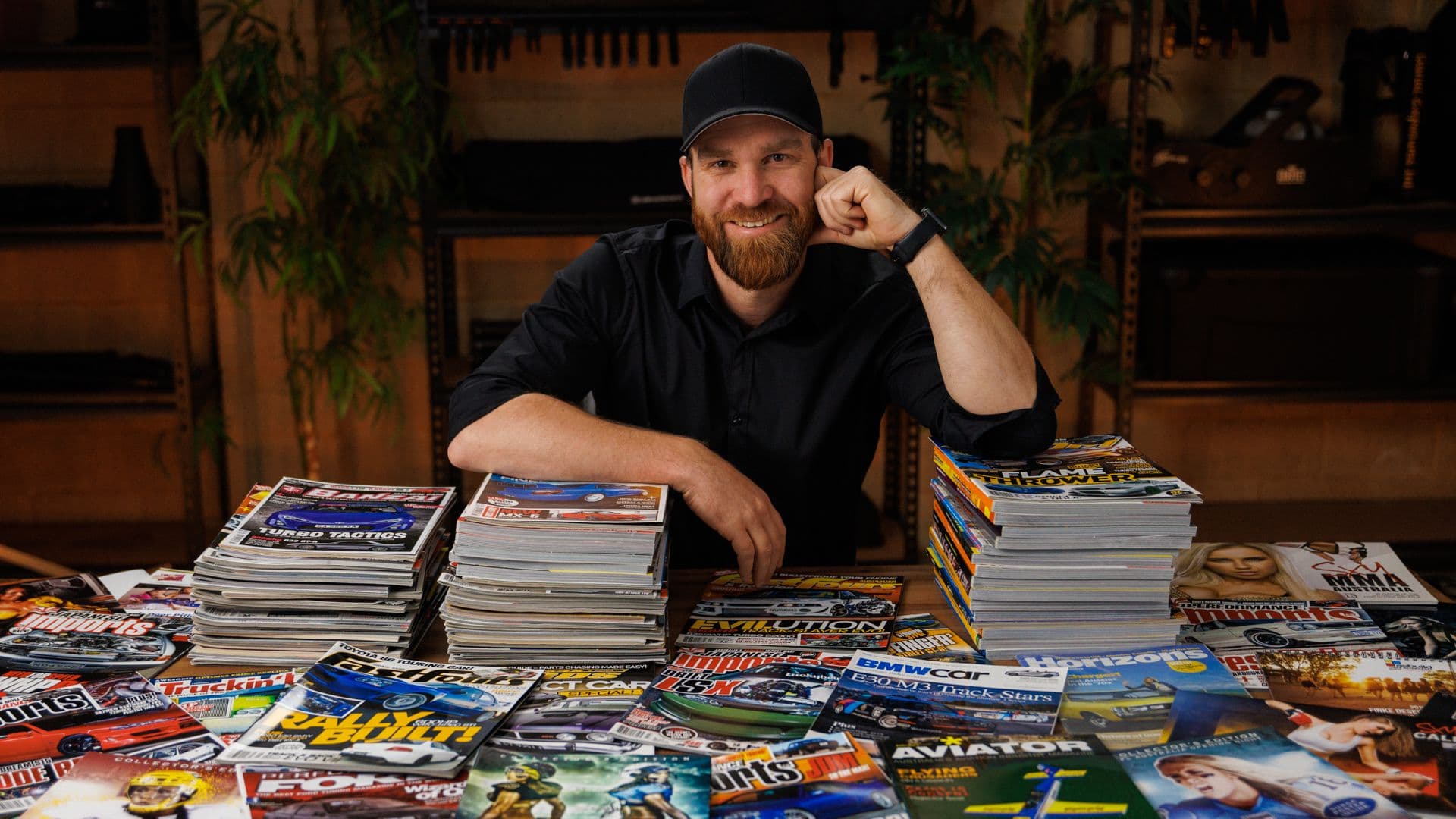 Brodie Butler with a wall of magazines featuring his published photography